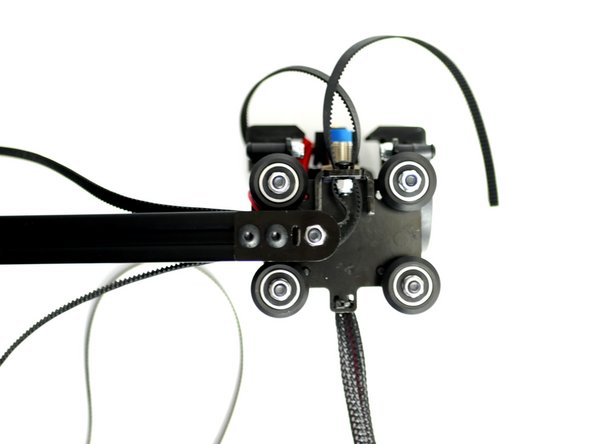 Bring the rollers up to the gantry beam making sure to trap the belt loop in the grooves of the beam with teeth facing inwards.