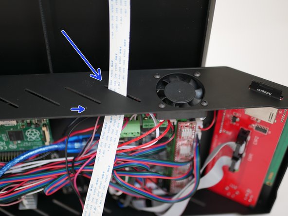 Feed the Pi Cam ribbon cable into the base through one of the slits.