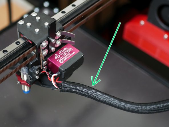 Take the remaining braided sleeving that you cut the sleeving of the heated bed cables from and use it to wrap the tool changer carriage cables.