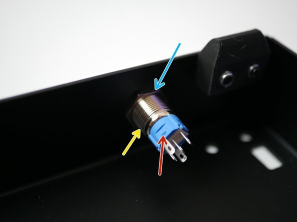 Push the switch in though the hole at the front of the base.