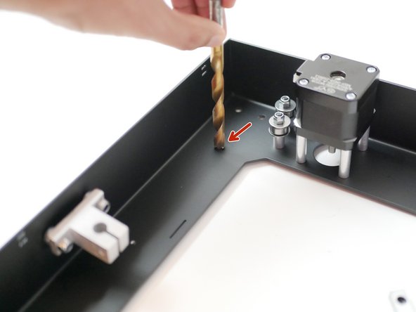 Use an oversized drill bit to carefully clear any burr left over from the threading of the rail mounting holes.