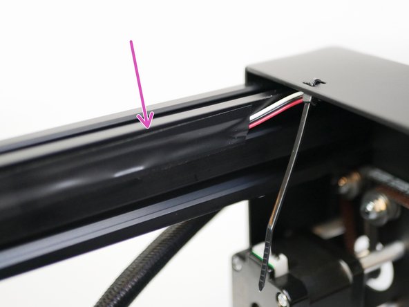 Route the cable down the 2040 extrusion. Use electrical tape to secure it in place.