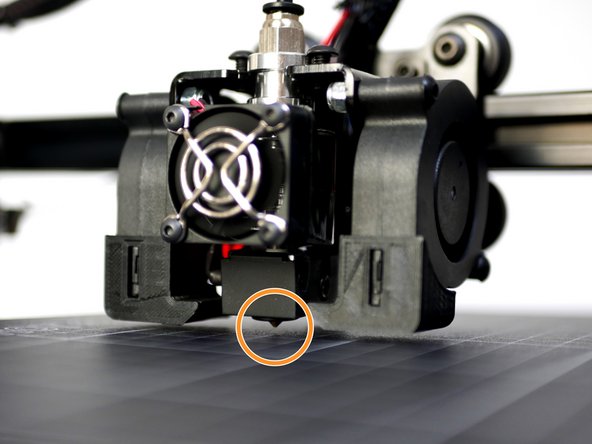 Lower the gantry by hand so that the nozzle comes close to the print surface. Once close enough the red light on the probe should come on.