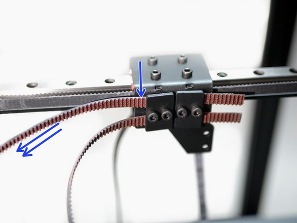 Pull the belt tight to hold it in place, but do not tighten the clamp down just yet.