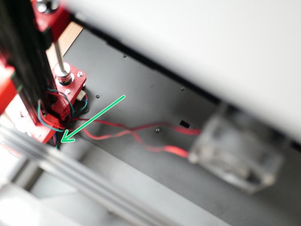 Feed the fans cable through the rear left hole on the base.