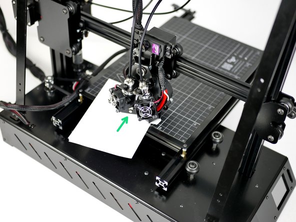 Use a folded piece of paper to feel the gap between the nozzle and print surface.
