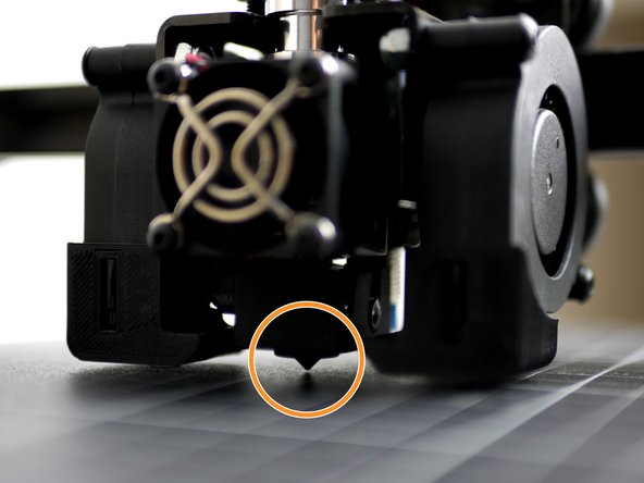 Lower the gantry so that the nozzle comes close to the print surface. Once close enough the red light on the probe should come on.