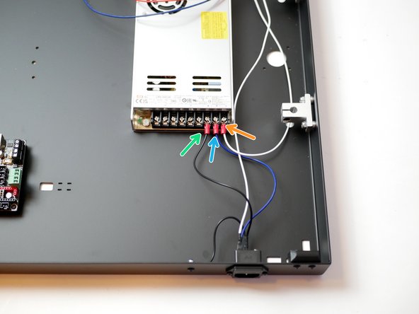 Connect the longer black cable from the socket to the power supplies earth terminal.