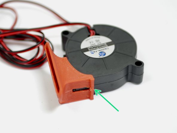 Fix the fan shroud onto the blower fan. The fan shroud is designed to snap in place.