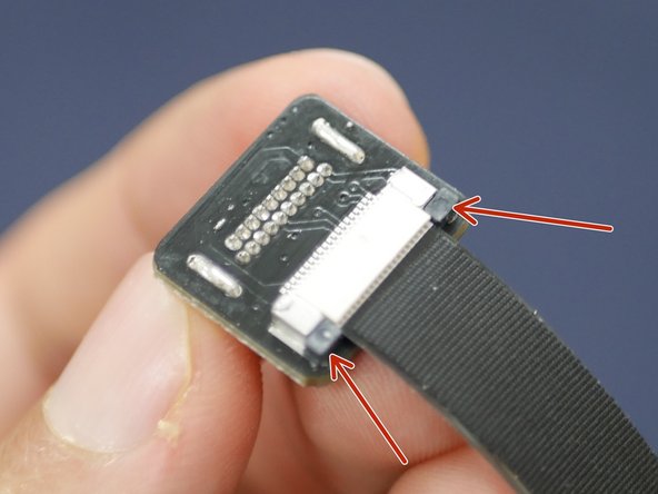 Next push the ribbon cable in, with the pin side facing up.