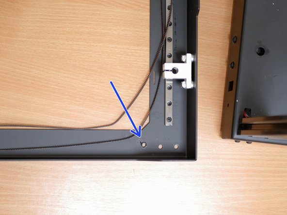 Unfasten the front two idler assemblies.