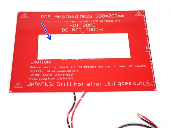 Peel off one side of the adhesive sticker and stick it to the centre of the flat side of the heated bed