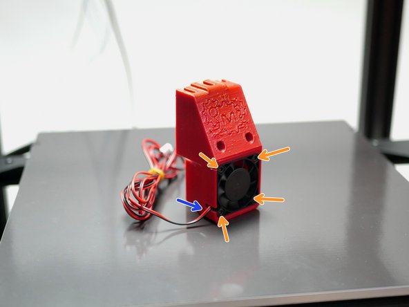 Ensure the fan is installed sticker side in and with its cable aligned with the slot.