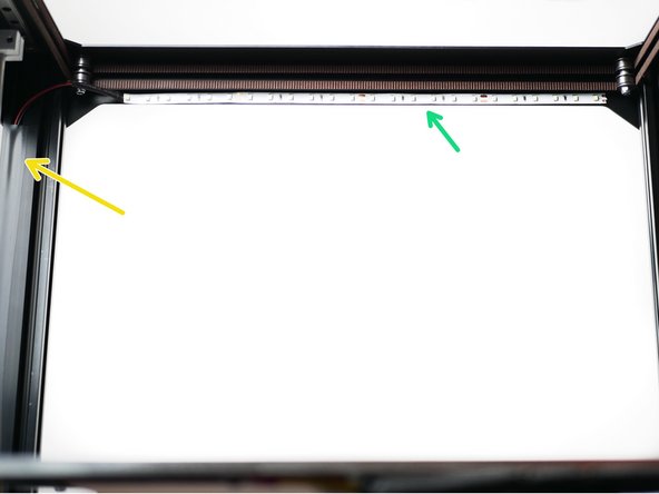 Stick the LED strip light to the inside front of the top panel.