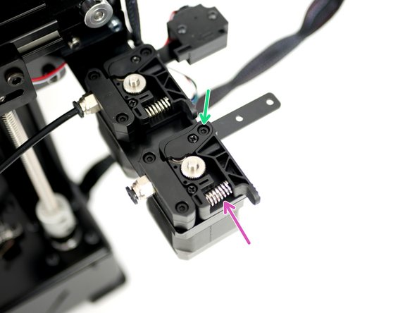 Place in position the Extruder Spring on the Back Plate.