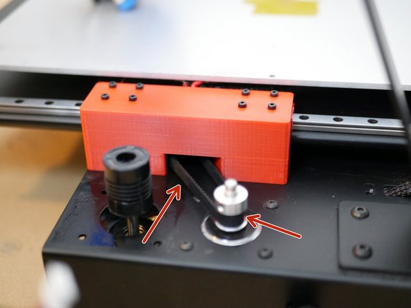 Re-install the belt by first wrapping it around the pulley on the motor and then feeding it in through the rear bracket and around the bearings.