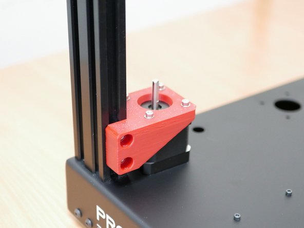 Secure those motor assemblies to the inside front of the frame as shown.