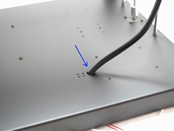 Feed the cables through the hole on the base.