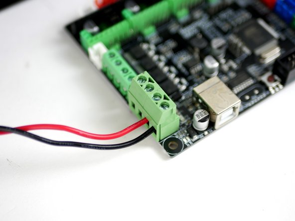 Using a small flat head screw driver fix the power cables into the control board like shown.