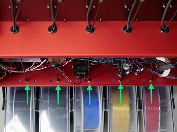 With the wiring and hardware checks completed you can push the PTFE filament tubes in through the couplings on the bottoms of the electronics box as shown.
