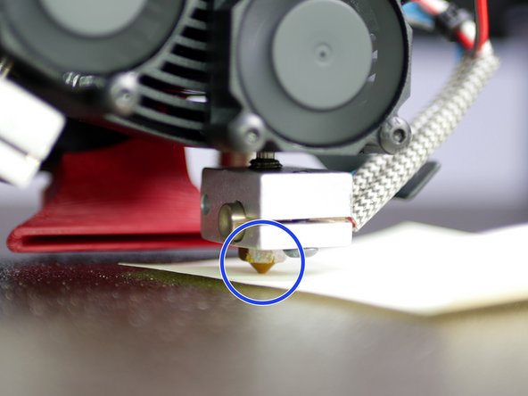 Lower the nozzle that sits higher by loosening the bolts holding it in place.