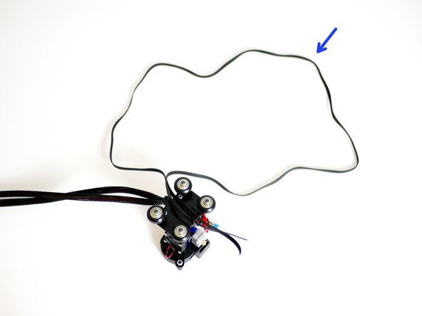 Take the remaining 1.4M of GT2 Timing Belt and feed it into the Y-Carriage as shown in the second image.