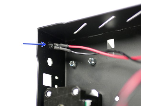 Thread it into the back of the base through the hole nearest the base side.