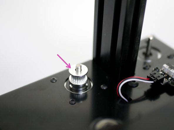 Drop a Pulley onto the shaft of the x-axis motor. Do not tighten the set screws yet.