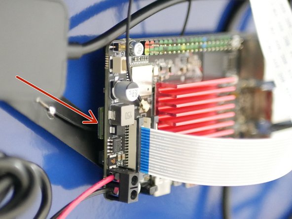 Carefully lay the printer down on its back. Let the base of the printer hang off the tables edge to allow access for the power cable.