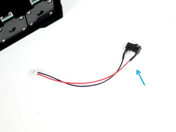 Fix the X-Endstop (it is the one with the shorter cable) to the inside of the base.