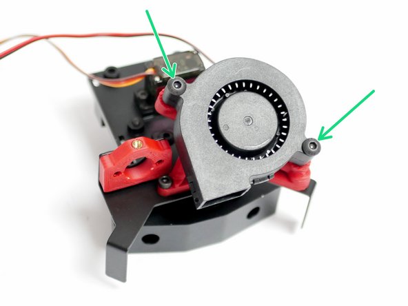 Secure the part cooling fan to the mount with two M4 x 20mm bolts.