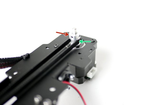Slide a pulley onto the shaft of the motor, orientating like shown, but don't fasten the grub screws yet.