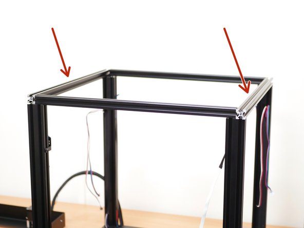 Take two of the extrusions and slide them over the heads of the bolt on the front and rear of the the printer.