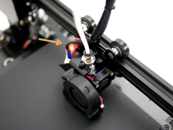 Lower the gantry so that the nozzle comes close to the print surface. Once close enough the red light on the probe should come on.  At this point the nozzle should only be a fraction of a milimeter above the print surface. The bottom of the probe should always remain above the tip of the nozzle.