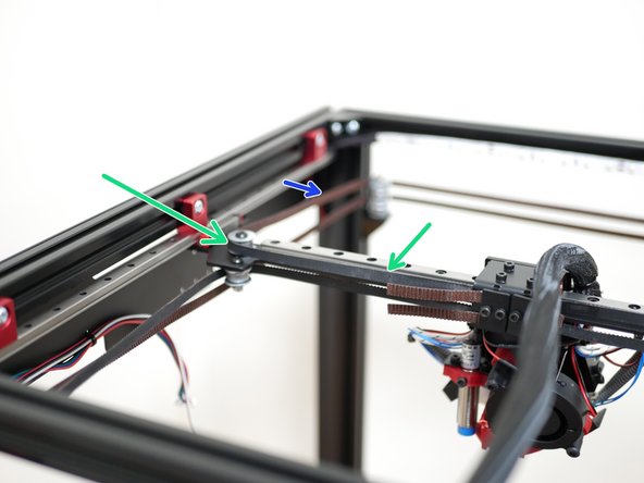 Repeat the same process for the top level belt by first looping it around the bearing on the left side of the gantry as shown.