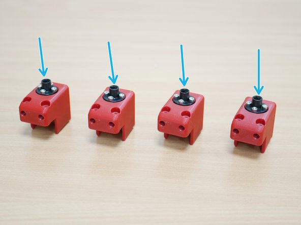 Fix these two lead screw nuts, with the two included in the upgrade kit, to the four 3d printed z-carriage parts.