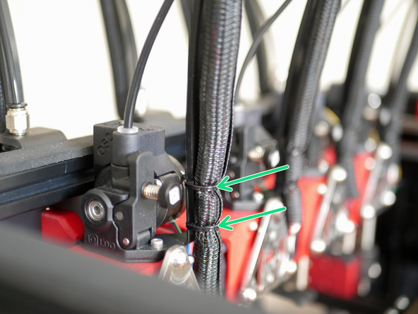The wider side of the cable support fixes onto the bracket on the side of the frame of the printer.