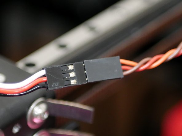 Connect to the servo cable the servo extension cable. Due to an oversight in the manufacturing of the cable harness you will need to use the included 3-pin male to male adapter here to connect the two cables.