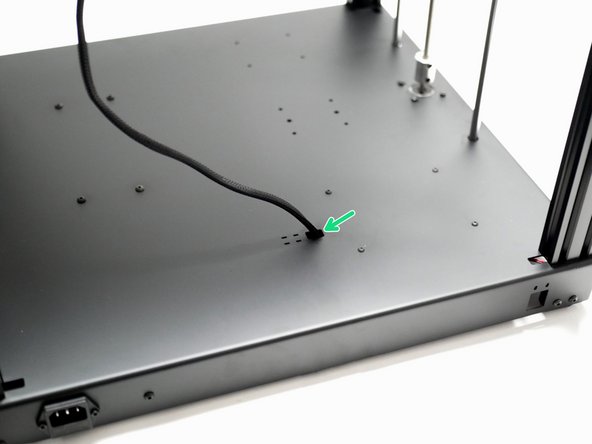 Feed the cables into the hole on the base and secure in place with two cable ties.