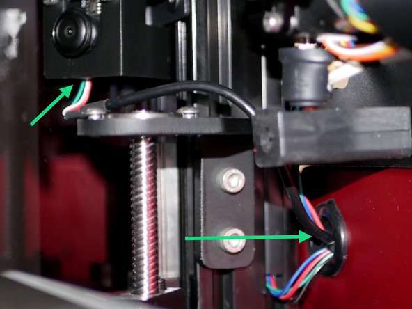 Route the camera cable through the upper inside hole of the electronics box.