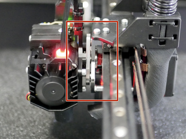 Manually move the tool carriage over to a print head and insert the cam pin into the tool plate.