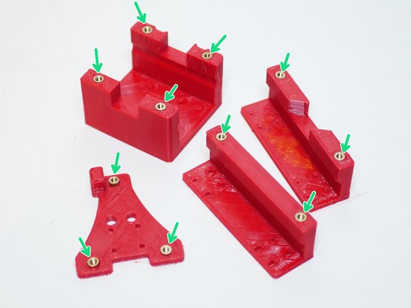 Using a soldering iron push the threaded inserts into the 3D printed parts as shown.