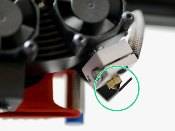 Adjust the ooze shields by bending the metal sleds until they are able to make contact with the tips of both nozzles.