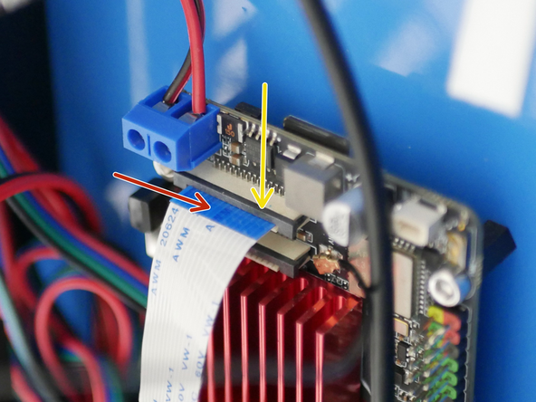 Feed the ribbon cable through the slit on the base and connect the other side to the Pi board.