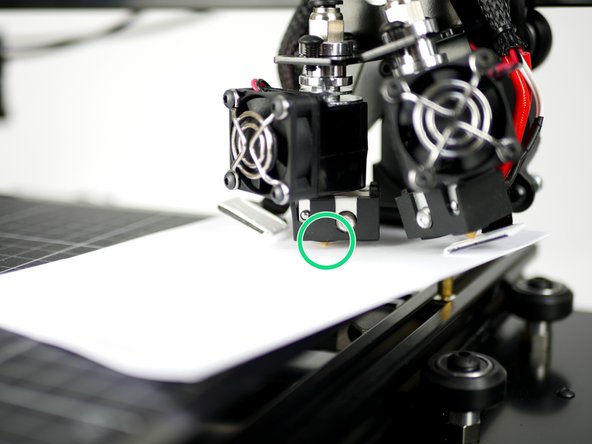 Use a folded piece of paper to feel the gap between the nozzle and print surface.