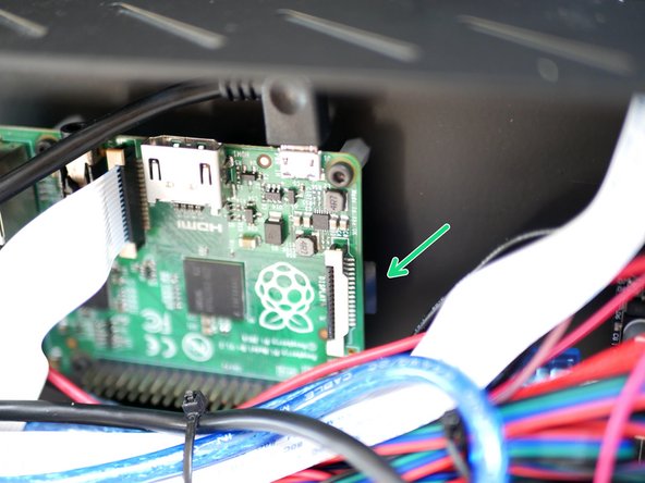 It is inserted into the back of the board with the golden contacts facing up. You may find it easier to unscrew the board from the mounts to gain better access.