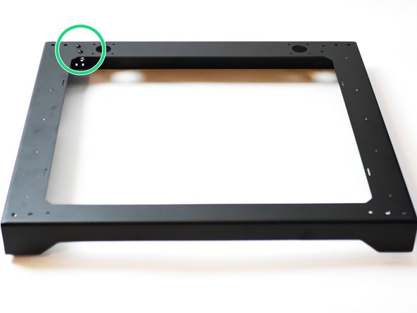 Install the two idler assemblies onto the rear left of the top panel as shown.