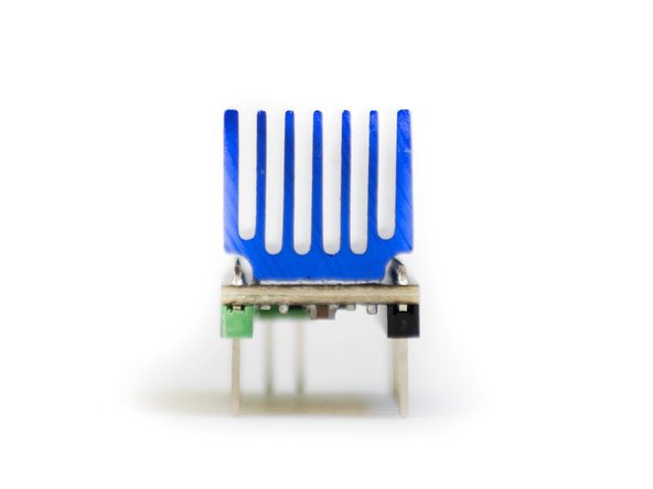 Prepare the five TMC2209 stepper drivers by removing them from their packaging and securing onto them their heat sinks as shown in the first image.