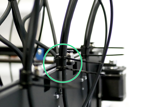 With the USB cable following the guide, secure them both to the dock bracket as shown.