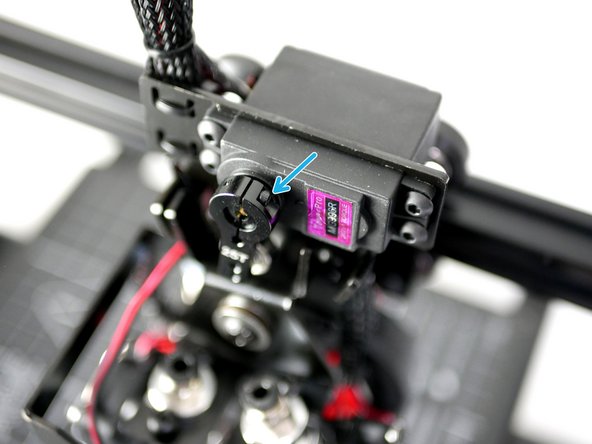 Install and tighten the two bolts to clamp the arm to the servo gear.